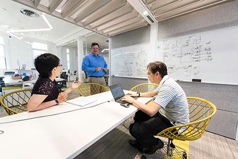 Three people working together on a problem.